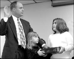 FARRAH MAFFAI  Paul A. Kapalko takes the oath of office to become a judge of the Superior Court of New Jersey on a Bible held by daughters Casey and Christina at the Monmouth County Courthouse in Freehold Jan. 4.