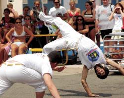 CHRISKELLY staff Cruzcredu Almog (l) and Prea Fernandez, members of the international troupe Roots of Brazil, spar during a demonstration of capoeira,    a Brazilian martial art, at Seashore Day Camp in Long Branch July 30.