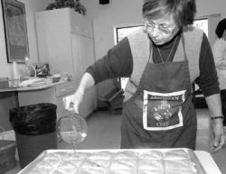 FARRAHMAFFAI staff Sonia Toufayan, Lakewood, pours a syrup over the cooked Kadaif during preparations for the Armenian Food Festival at St. Stepanos Church in Elberon this weekend.