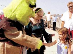 CHRIS KELLY staff Friendly ogre Shrek and Princess Fiona greet Billirose Brandner, 5, of Boston, at the 15th annual Oceanfest celebration, which took place on the beachfront Promenade in Long Branch on July Fourth. 