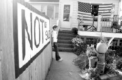 Above, Daisy Hoagland pauses in front of her home on Ocean Terrace in Long Branch, which is slated to be razed for redevelopment. Below, supporters take part in a walk along the oceanfront to protest what members of the MTOTSA alliance say is an abuse of eminent domain.  