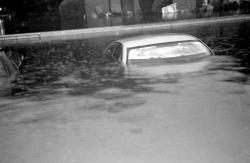 This submerged auto is one of 30 ruined by the flooding at the senior complex. 