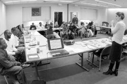 PHOTOS BY SEAN BRADY Melanie A. Swain (far right), of Planned Parenthood of Central New Jersey, discusses the use of protection in fighting HIV/AIDS infection with a group at Monmouth University Nov. 30.