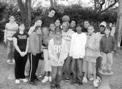Members of Team Jump Off gather in Tonya Badillo's yard to play basketball.