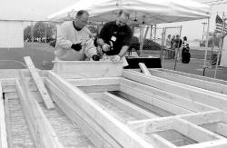 PHOTOS BY CHRIS KELLY staff Brian Gill and Dean Margarites help Habitat for Humanity of Long Branch during a two-week "community build," to construct prefabricated exterior wall panels for multiple homes in the parking lot of Monmouth Mall on May 2.