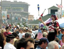 CHRIS KELLY staff Stiltwalker Ben Lipman, North Plainfield, practices the delicate art of juggling above the crowd attending Oceanfest, the city of Long Branch's beachfront Fourth of July celebration. For more pictures, see pages 28 and 29.