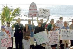 MIGUEL JUAREZ staff Surfers, divers, fishermen and environmental activists held a press conference on the Long Branch boardwalk Monday to protest large-scale beach replenishment projects which they say are detrimental to the coast. The protest coincided with the annual conference of the American Shore and Beach Preservation Association, a group that supports the projects. 