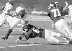 PHOTOS BY SCOTT PILLING staff Above, Monmouth's Jamaal McClintock takes down San Diego's J.T. Rogan during Saturday's Gridiron Bowl in West Long Branch. At left, MU's Shane Sharpley tries to outrun San Diego's Patrick O'Neill to the end zone. Below, Monmouth's Erik Yngstrom is held as he tries to get to the quarterback. 