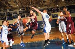  Red Bank Regional High School&rsquo;s Jack Navitsky (c) drives through a swarm of Holmdel High School defenders, led by Brett Lambert (#20), on his way to the basket during the Jan. 26 game played in Holmdel. The visiting Bucs fell, 50-35.  ERIC SUCAR staff 