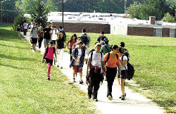 JEFF HUNTLEY Students at East Brunswick&rsquo;s Churchill Junior High School start their 600-foot trek to class at the Roselle Smith annex. A school board referendum calls for the construction of an enclosed connector building between the two, which would house a new gymnasium, cafetorium, science labs and demonstration rooms. 