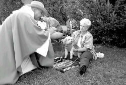 MARIE ORTIZ Carol Labowicz, Spotswood, holds her dog, Beaches, for the Rev. Joe Patronik to bless at the blessing of the pets last weekend. 