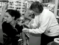 MARIE ORTIZ  Luba Lucyk, R.N., of the Visiting Nurse Association, gives Denise Gagliardi of Monroe a flu shot at the Monroe Park Pharmacy on Dec. 16. 