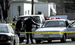 PHOTOS BY JEFF HUNTLEY  Police investigate the crime scene after a fatal shooting in South River last week. 