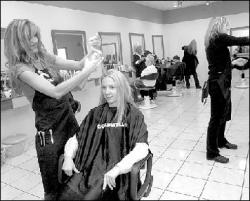 VERONICA YANKOWSKI  Hairstylist and co-owner Wanda Sutton works on a client&rsquo;s hair at the recently opened Angles Hair Design in North Brunswick on Route 1.