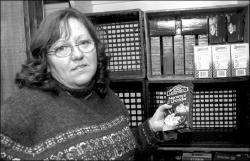 PHOTOS BY VERONICA YANKOWSKI Janet Curtis, (above) who chairs the Welfare Committee for the board of directors at the Jamesburg Presbyterian Church, says the cupboards can use more donations of all types of food for the needy. At right, Dick Asch helps David Modzelewski, of Boy Scout Troop 60 in Monroe, carry boxes of food at the Jamesburg Presbyterian Church on Friday.