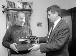 VERONICA YANKOWSKI Congressman Rush Holt delivers an American flag to James Samuel during a visit to Samuel&rsquo;s Jamesburg home on Friday.