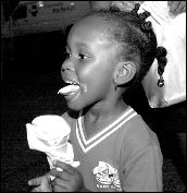 Fairgoers can indulge in their favorite fair foods, such as sweet ice cream.