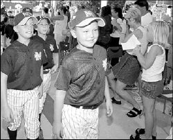 Members of Monroe&rsquo;s 10-year-old Little League team enter the township&rsquo;s Community Center during a pep rally July 31 before they headed to Bakersfield, Calif., for the Babe Ruth World Series. The team, having conquered the Middle Atlantic Region, fell 0-2 over the weekend to teams from Kentucky and Arizona. Teammates received shirts honoring their achievements during the pep rally. For more, see page 29.    PHOTOS BY DAWNMARIE SANNWALDT