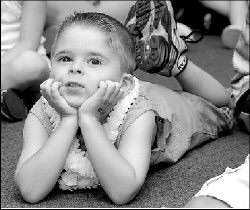 JERRY WOLKOWITZ  Joseph Burgio, 9, (above) participates in the story-telling experience, &ldquo;Clams Can&rsquo;t Sing,&rdquo; at the Spotswood Public Library&rsquo;s &ldquo;Under Sea Party&rdquo; Tuesday. At right, Christina Askander, 8, makes a fish.