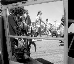 The crowd at the second annual Tonkery Boulevard Street Festival in Jamesburg is reflected in a mirror.  At left, classic and modern cars attracted the gaze of passers-by at the festival Saturday.