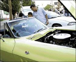 FARRAH MAFFAI Luis and Esteban Pineda look inside a Chevrolet Corvette at the Aug. 15 South River Cruise Night, the first in a series of classic car nights planned for the borough.