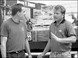 VERONICA YANKOWSKI Contractor Bryan Burns (l) talks with sculptor Blaise Batko at the future site of the township&rsquo;s Sept. 11 Memorial Park on Tuesday morning, when workers began to set the monuments in place.