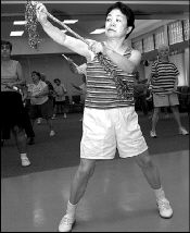 FARRAH MAFFAI Sharuko Singh is among the many East Brunswick senior citizens taking advantage of the exercise programs offered at the Senior Center three times a week. Here, she uses a baton during the aerobics program Friday.