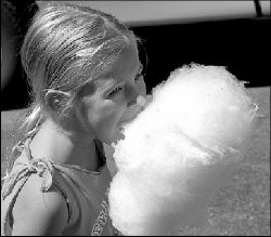 FARRAH MAFFAI Brittany Shapter, 6, dives into her cotton candy during the Crab Tree Festival, held Saturday along Railroad Avenue in Helmetta.