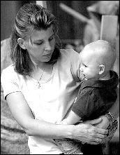 FARRAH MAFFAI Linda Dickinson holds her son, Patrick,  at the Monmouth County Remembering September 11, 2001 ceremony at Brook-dale Community College. They lost Lawrence Patrick Dickinson, Patrick&rsquo;s father and Linda&rsquo;s husband.
