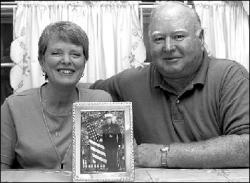 FARRAH MAFFAI Mary Beth and John Dorney proudly display a photograph of their son, Capt. Michael Dorney, who served as a logistics officer in Pakistan and returned home safely.