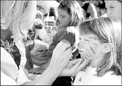 Anastasia Furnari has her face  painted during the fair. PHOTOS BY CHRIS KELLY