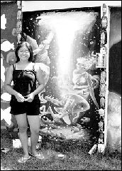 Artists Cathy Gao, at left, and Bob Rakita, at right, members of the Visual Arts League, East Brunswick, painted murals along the walls of the YMHA Swim Club on Dutch Road as part of an ongoing project undertaken by the league.