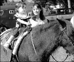 FARRAH MAFFAI Ponies provided some enjoyment for Alexandria McSweeny and her 23-month-old daughter during Saturday&rsquo;s Village Street Fair in East Brunswick.