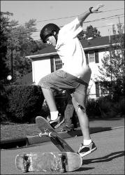 FARRAH MAFFAI Brent Evans, 14, jumps over a skateboard on a Helmetta street Monday.