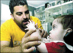 VERONICA YANKOWSKI Steven Pepi of Helmetta plays with his son, Steven Gerard Pepi, who has congenital muscular dystrophy.