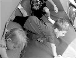 Joe Duffy, 5, crawls through the Team Challenge.