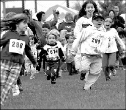 Kids make a run for it during the annual East Brunswick Road Races, held Sunday at the Crystal Springs Aquatic Center, Dunhams Corner Road. At right, Rachel Hecht, 3, of East Brunswick, waits for her sisters to finish one of the races.  PHOTOS BY VERONICA YANKOWSKI