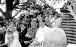 PHOTO COURTESY OF SHELDON HARRIS President George W. Bush (above,        center) watches the Buddy Ball game with league founder Chet Dudek in Washington, D.C., Sept. 22. During the game, South Brunswick Buddy Ball player Craig Harris (at right) scores a run on the White House lawn.