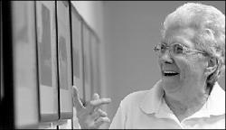 VERONICA YANKOWSKI Nila Boyko, president of the Friends of the Senior Center in Monroe, enjoys a look at one of the pictures on exhibit at the Senior Center.