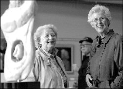 PHOTOS BY VERONICA YANKOWSKI  Miriam Coyne (l) and Joan Leon look over the &ldquo;Circle of Life&rdquo; sculpture by Evelyn Ackerman during the opening reception of the Monroe Township Cultural Arts Commission&rsquo;s third annual juried art show Oct. 13 at the Monroe Township Library. At right, Nancy Ballard Frank&rsquo;s &ldquo;Still Life With Apples&rdquo; was among the works of Monroe residents on display last week for the township-sponsored juried art show.