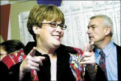 PHOTOS BY FARRAH MAFFAI Catherine Diem shows her excitement after learning she won the council election in East Brunswick Tuesday night. She is flanked by her victorious running mate, David Stahl.