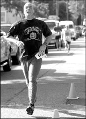 VERONICA YANKOWSKI Timothy Holton of East Brunswick crosses the finish line of the 10K Frost on the Pumpkin race in South River on Sunday.