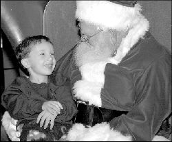 FARRAH MAFFAI Santa Claus made an early appearance Saturday at Brunswick Square Mall, Route 18, East Brunswick, arriving aboard a U.S. Postal Service vehicle, sans reindeer and elves. He met with youths, including 4-year-old Michael Newton (pictured), for two hours.