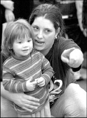 PHOTOS BY VERONICA YANKOWSKI Jennifer Noonan (above) shows her daughter, Michelle, 2, where to run in the 24- to 36-month-old portion of the annual East Brunswick Turkey Trot, held Sunday at the township&rsquo;s senior center.