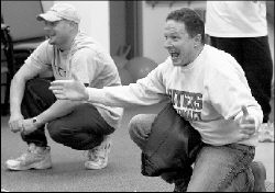 Tom Gambino (above, r) enthusiastically awaits the arrival of his son at the Turkey Trot finish line.