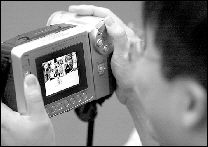 Frank Lee films his daughter, Amanda, during the crawling race.