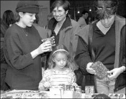 VERONICA YANKOWSKI Leya Strauss (l), Aviva Strauss, 7, and Beth Stuckey (r) check out some of the  crafts at the Israel Solidarity Fair in East Brunswick Sunday.
