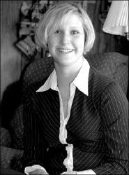 FARRAH MAFFAI Melissa Michalak, who is the first female police officer to be sworn in on the Milltown force, smiles while at home in the borough last week.