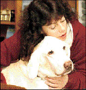 JERRY WOLKOWITZ Gail Drysdale hugs Bo, a yellow labrador, in her Helmetta home last Monday. Bo is owned by Drysdale and is not up for adoption.