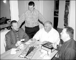 DAWNMARIE SANNWALDT The creators of Proclaim! play their game at the East Brunswick home of Raj Kittur Monday evening. From left, are Joe Pisano, Scott Sayers, Kittur and Bob Henderson.
